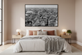 Load image into Gallery viewer, Bedroom with a large framed cityscape print on the wall