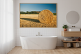 Load image into Gallery viewer, Golden agricultural field with hay bales at sunset, serene country photo print.