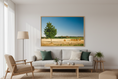 Bild in Galerie-Betrachter laden, Tranquil rural summer view featuring a green tree and golden hay bales in open farmland.