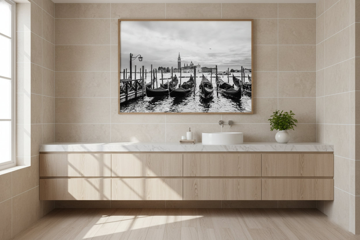 Bathroom with wooden vanity, white countertop, and framed artwork on the wall.
