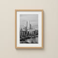 Load image into Gallery viewer, Framed black and white cityscape of Canary Wharf London print on a beige wall
