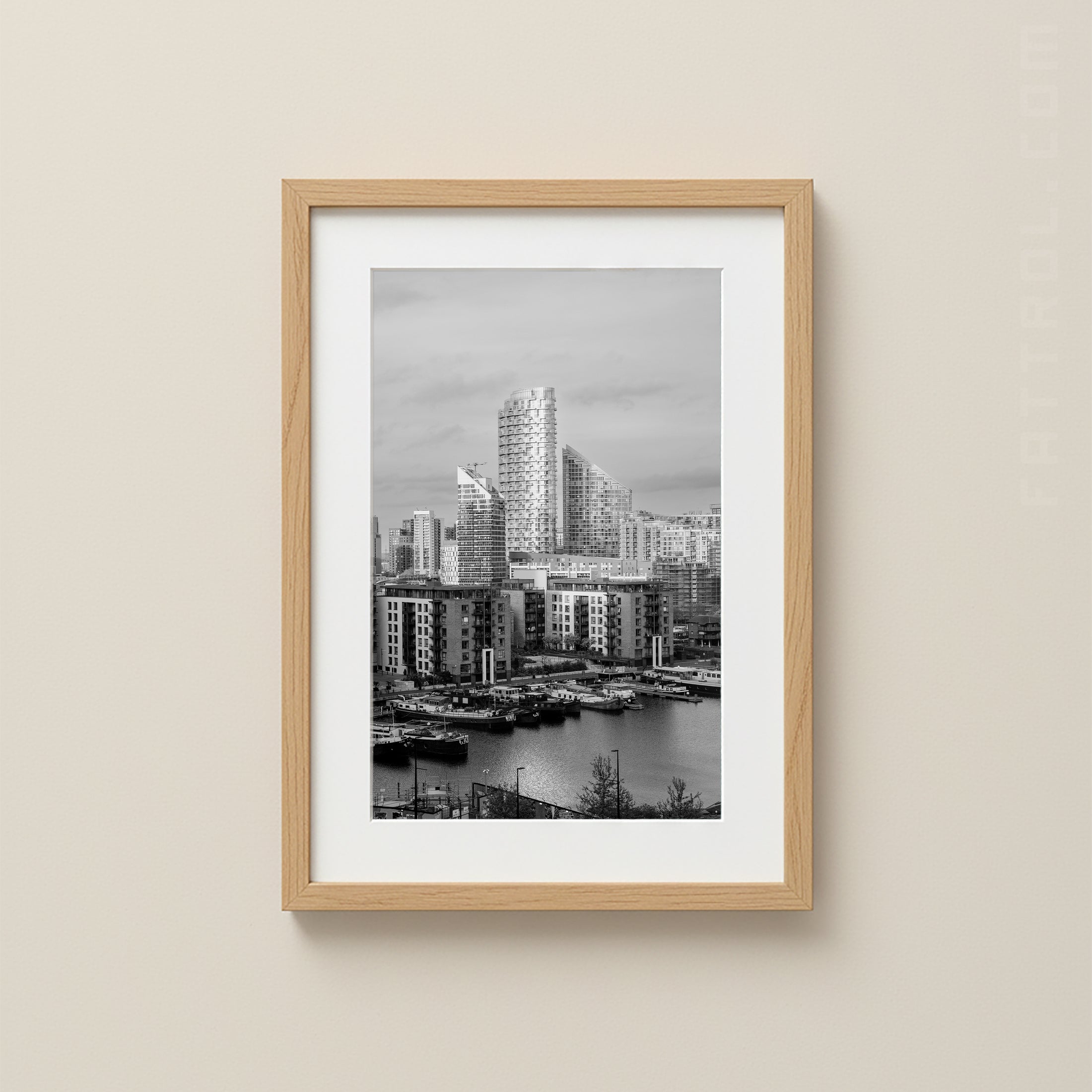 Framed black and white cityscape of Canary Wharf London print on a beige wall