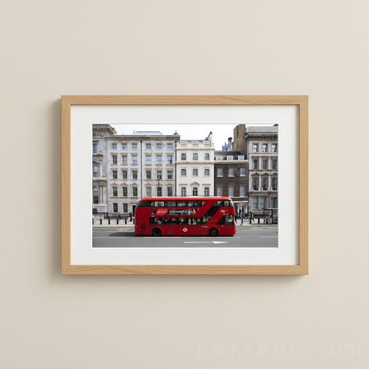 London Double Decker Bus photograph of a red double-decker bus on a city street with buildings in the background.