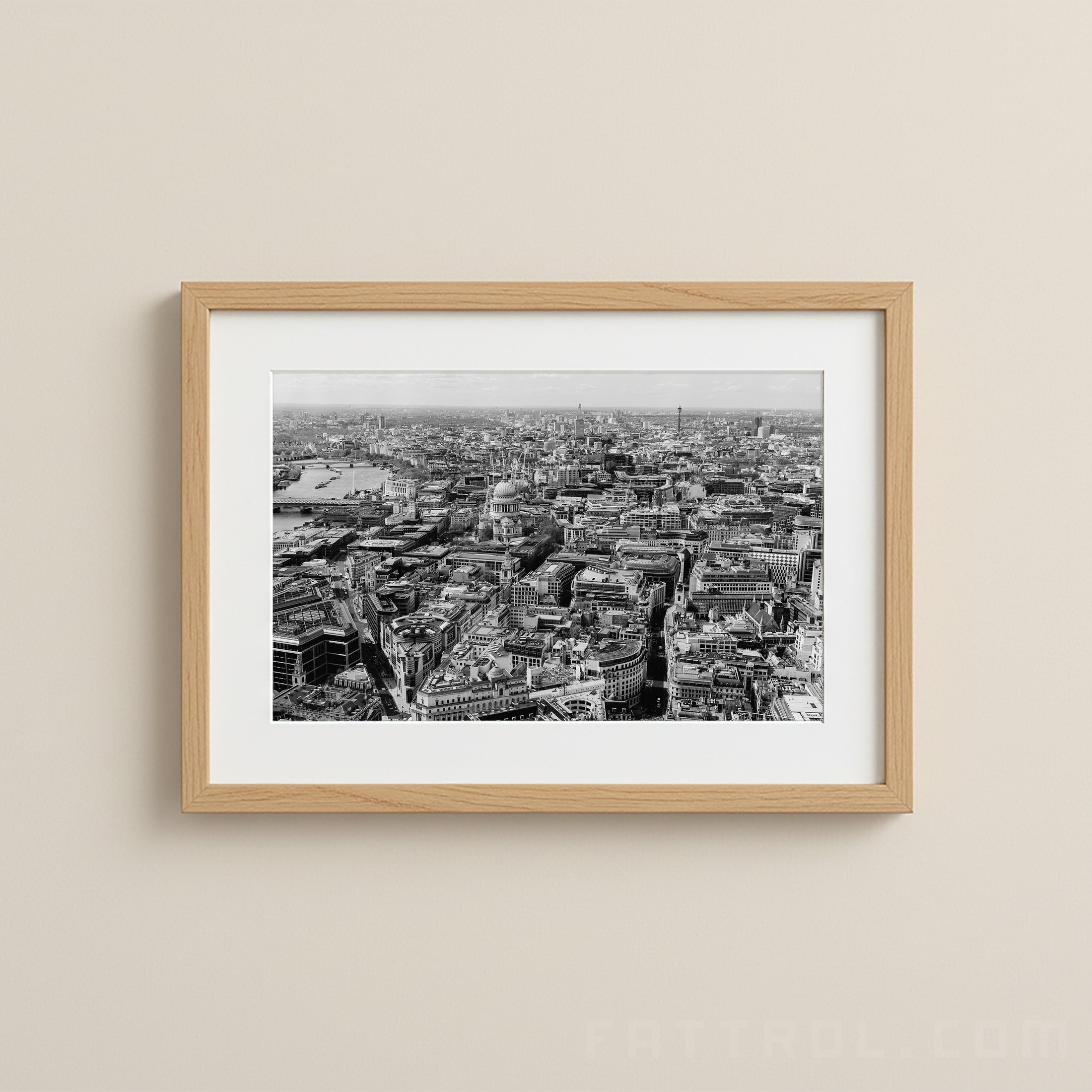 Framed black and white cityscape print on a beige wall