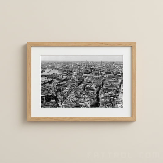 Framed black and white cityscape print on a beige wall