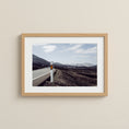 Load image into Gallery viewer, Winding volcanic road in Lanzarote under a soft blue sky.

