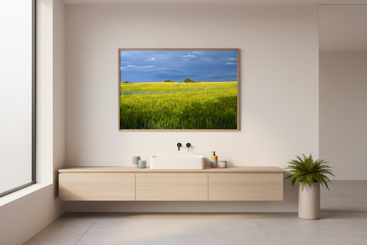 Modern bathroom with a large TV displaying a scenic landscape, wooden vanity, and plant.