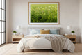Load image into Gallery viewer, Bedroom with a large framed picture of a grassy field above the bed.
