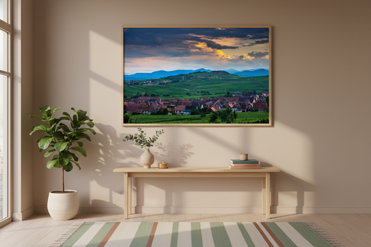 Picturesque French countryside with vineyards and rooftops under a dramatic evening sky