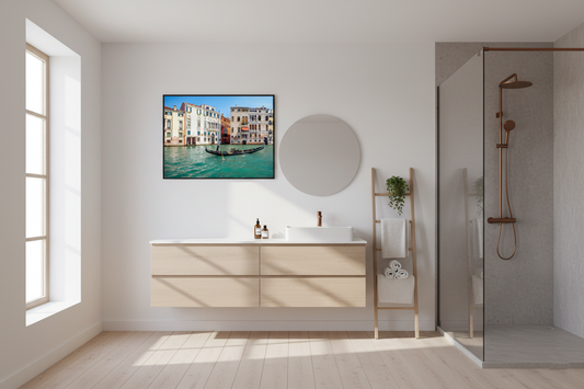 A gondolier steering a traditional Venetian gondola along the turquoise waters of Venice’s Grand Canal
