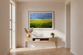 Bild in Galerie-Betrachter laden, Framed artwork of a green field hanging on a wall in a room with a wooden floor.
