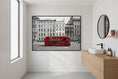 Load image into Gallery viewer, Classic red London bus in motion against elegant Georgian and Victorian buildings — urban travel wall art.
