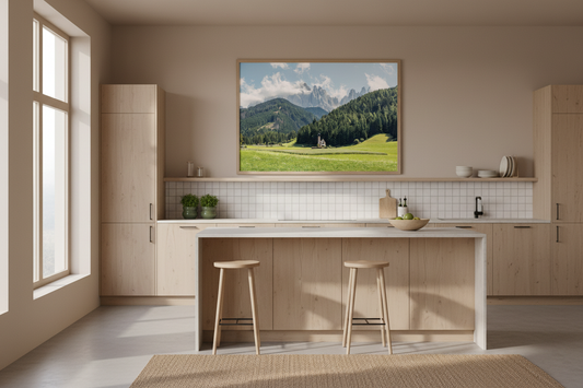 Modern kitchen with a painting of a mountain landscape on the wall.