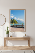 Load image into Gallery viewer, Italian waterfront landscape with trees, lake, and mountains under a blue sky
