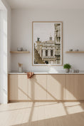 Load image into Gallery viewer, Modern kitchen with wooden cabinets, a framed picture on the wall, and a plant.
