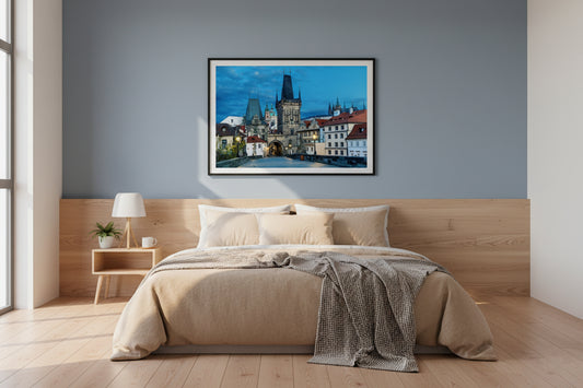 Modern bedroom with a bed, nightstand, and wall art depicting a cityscape.
