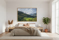 Load image into Gallery viewer, Bedroom with a large landscape painting on the wall, plants, and wooden furniture.
