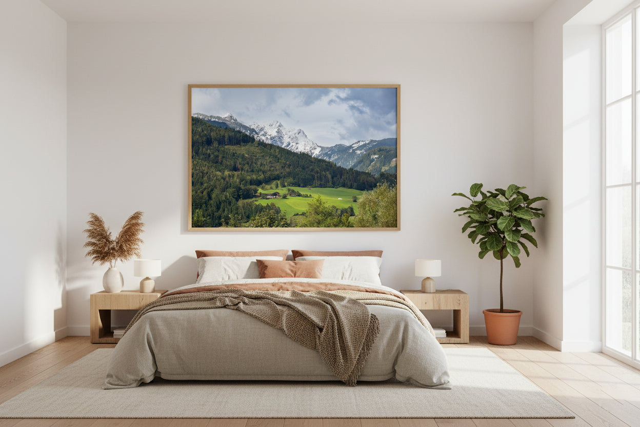 Bedroom with a large landscape painting on the wall, plants, and wooden furniture.