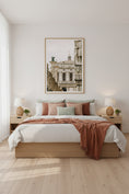 Load image into Gallery viewer, Neatly made bed with pink and white bedding in a bedroom with a framed picture on the wall.
