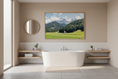 Load image into Gallery viewer, Modern bathroom with a freestanding bathtub, round mirror, and scenic wall art.
