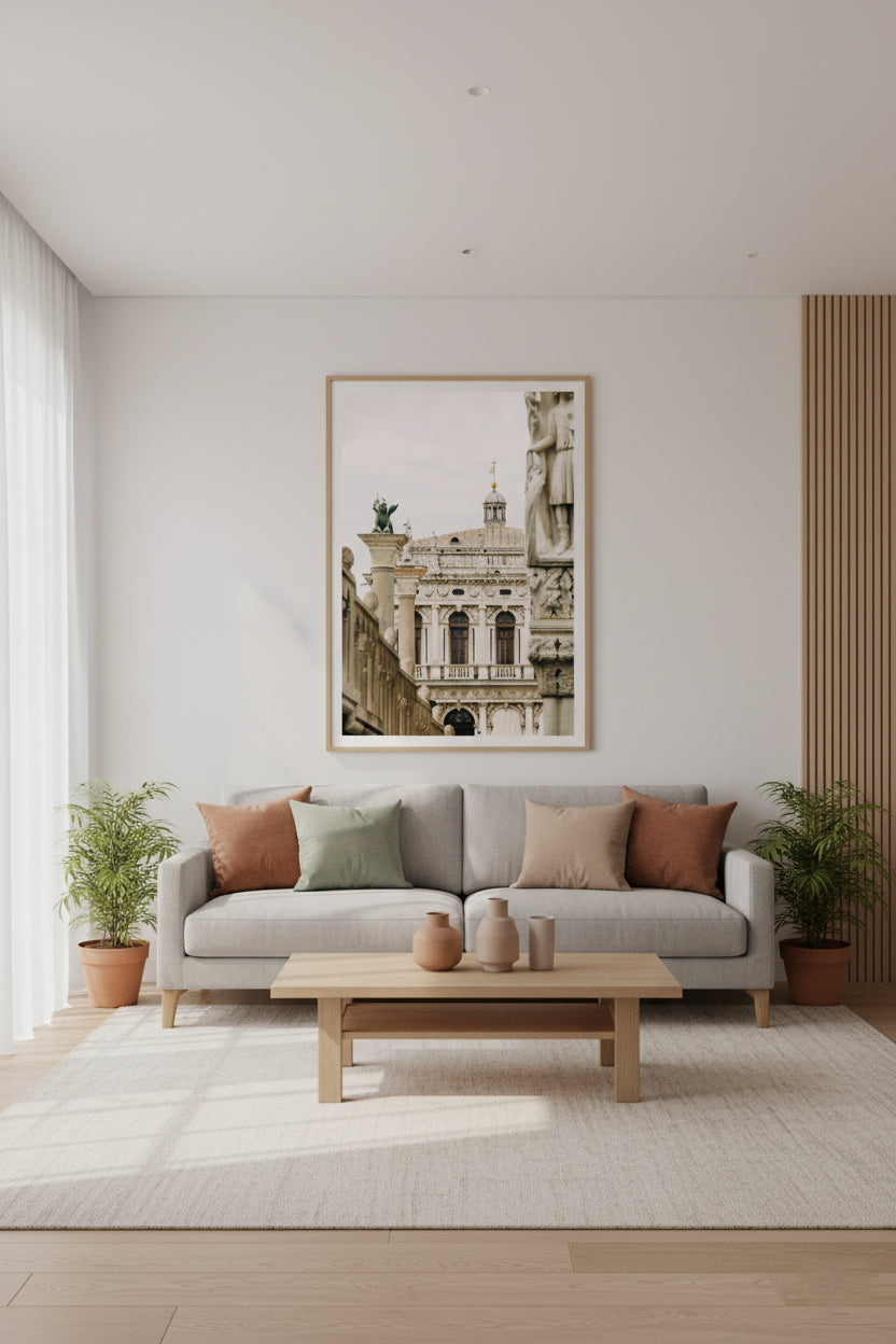 Living room with a gray sofa, wooden coffee table, and framed artwork on the wall.