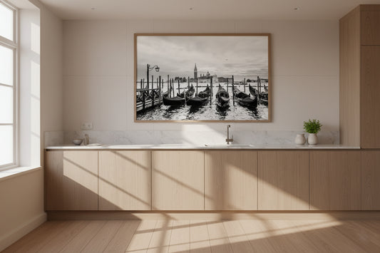 Modern kitchen with a large framed photograph of a dock scene on the wall.